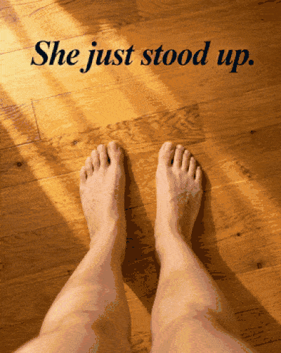 She just stood up — bare feet on hardwood floor in morning sunlight